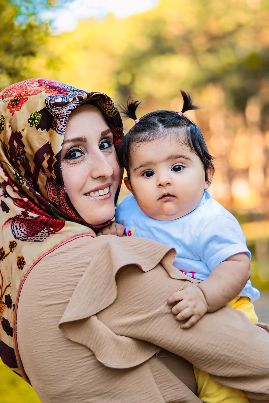 A mother holding her smiling baby